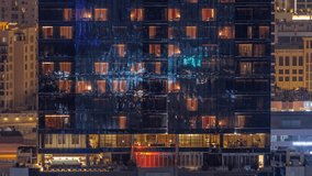 Office and residential buildings windows illuminated at night timelapse. Glass architecture, conference hall and restaurant in corporate building at evening with glowing orange lights - Powered by Shutterstock - Get 15% off with code: PIKWIZARD15