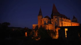 Corvin (Hunyad) Castle in Hunedoara during the night. 4K wide angle video pan camera movement with this amazing medieval castle landmark in Romania.