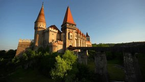 Corvin (Hunyad) Castle in Hunedoara during the sunset. 4K wide angle video with this amazing medieval castle landmark in Romania.