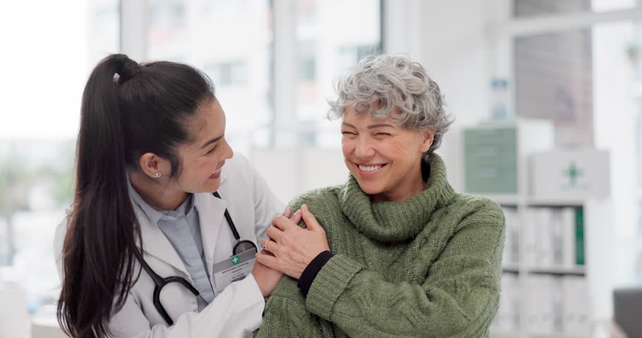 Happy, care and face of a doctor with a woman for medical trust, healthcare and help. Laughing, hug and portrait of a young nurse with a senior patient and love during a consultation at a clinic Royalty-Free Stock Footage #1106317179