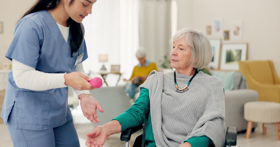 Physiotherapy, nurse and senior woman in wheelchair, muscle exercise and physical therapy support at home. Retirement, nursing people or physiotherapist doctor helping elderly patient with disability | Shutterstock HD Video #1106317307