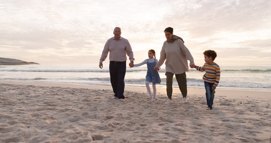 Walking, children and grandparents holding hands at beach for fun vacation, holiday or adventure at sunset. Senior man, woman and kids together at ocean for family time with love outdoor in nature