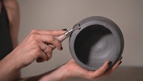 caucasian woman working with clay. a female potter makes a product from clay. close-up of a clay product. slow motion video. High quality Full HD video recording