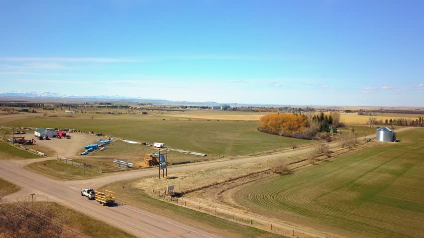 Aerial Shot Of Pickup Truck With Trailer Moving On Road Amidst Field During Sunny Day - Billings, Montana