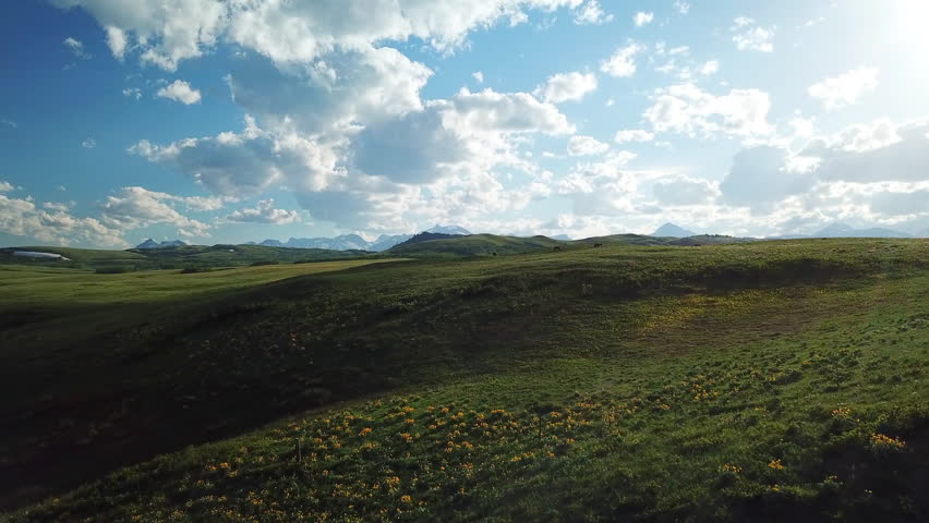 Aerial Shot Of Beautiful Landscape Against Cloudy Sky On Sunny Day, Drone Flying Over Meadow - Billings, Montana