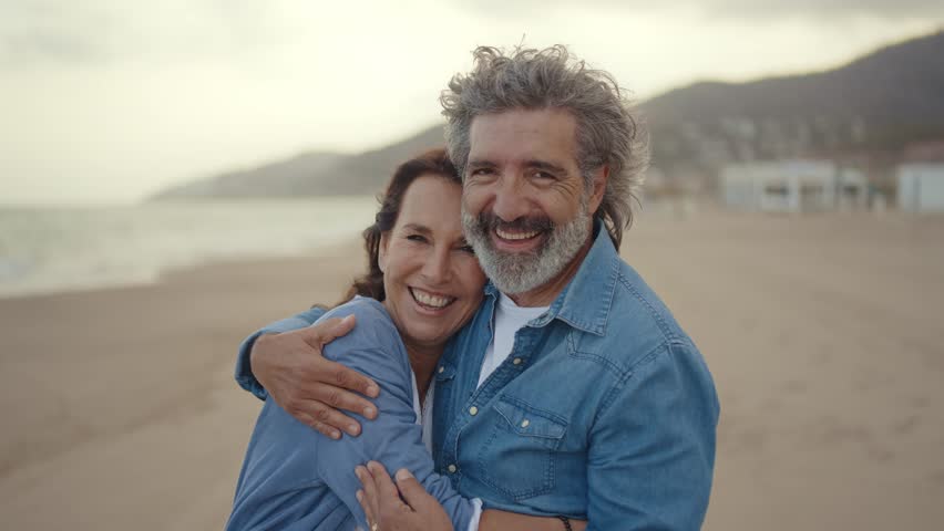 Cinematic video of a senior couple spending time on the beach and making different activities near the ocean. Romantic concept about a man and a woman in love. Lifestyle in the seniority age Royalty-Free Stock Footage #1106326443