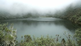 Clouds and fog over lake in the mountain in rain forest. South America. Video time lapse. Wonderful place. Black lake.