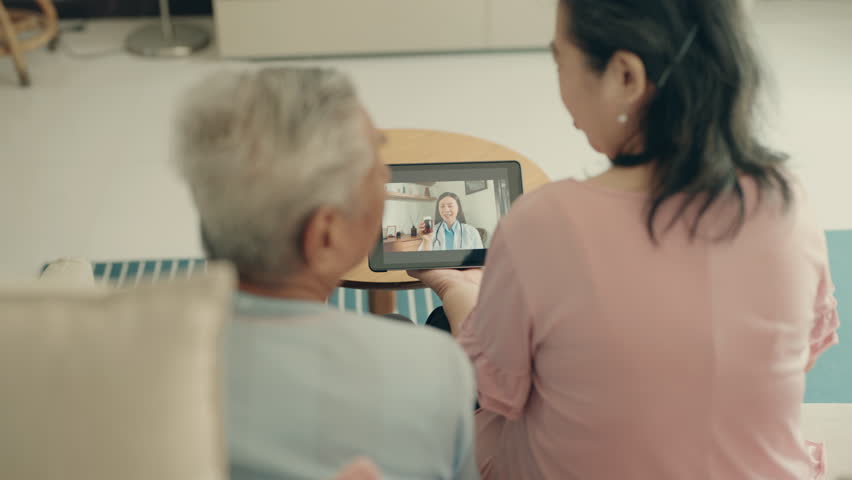 Connected Care: Senior Couple Video Call to Seek Advice from a Female Doctor, Embracing Modern Healthcare Solutions Royalty-Free Stock Footage #1106326989