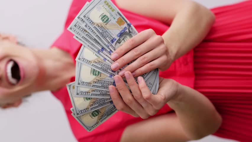 vertical footage excited smiling woman showing cash money 1000 american dollars banknotes, hands with money close up, Income, winner and Business concept. Royalty-Free Stock Footage #1106327457