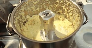 The process of making puree in a blender. The moment of salting.