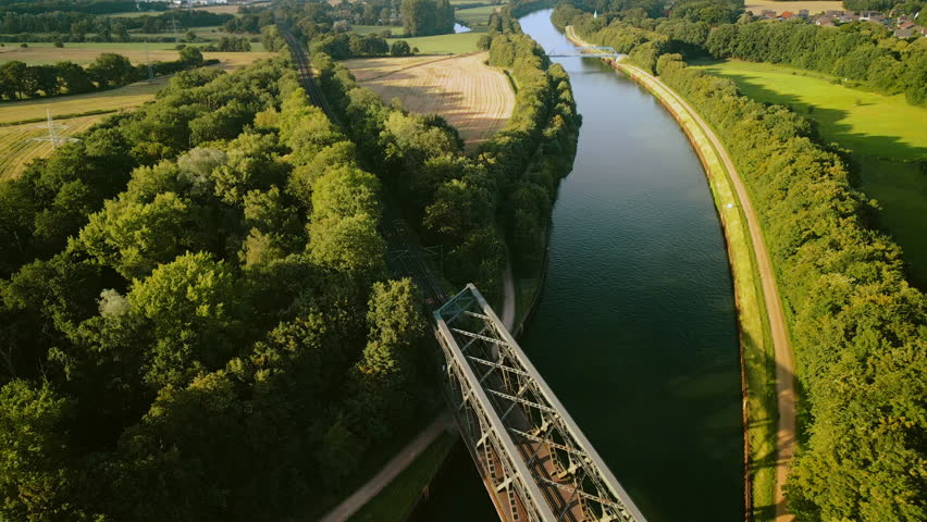 Haltern-am-See, Germany - July 14 2023: DB Regional train crossing a river bridge in sunny Sumer day, aerial footage  Royalty-Free Stock Footage #1106329477