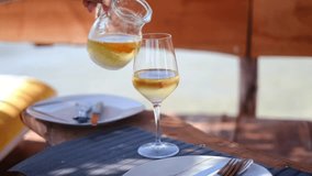 Home white wine pouring into a glass on a beach, Albania. High quality 4K footage - Powered by Shutterstock - Get 15% off with code: PIKWIZARD15