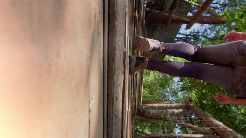 Young woman walking on a footbridge in nature