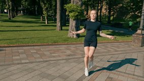 Fitness young sportsman girl with tattoos in the morning doing sports jumping rope during exercise outdoors in the city in health park - Powered by Shutterstock - Get 15% off with code: PIKWIZARD15
