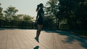 Fitness young sportsman girl with tattoos in the morning doing sports jumping rope during exercise outdoors in the city in health park - Powered by Shutterstock - Get 15% off with code: PIKWIZARD15