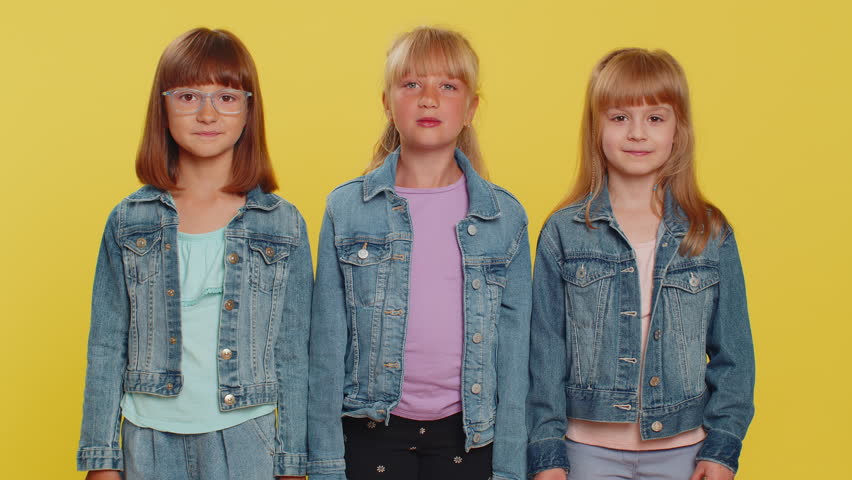 Excited happy teenage girls winning prize, celebrate birthday. Little child sisters celebrate success. Three siblings children kids becoming surprised about sudden dream come true on yellow background | Shutterstock HD Video #1106339077