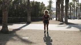 African woman running along a public park