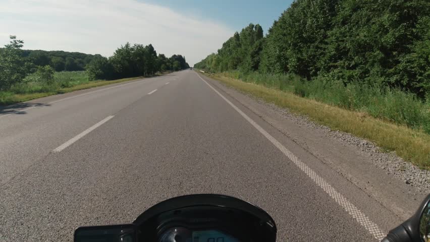 Motorcycle riding on the highway asphalt road, summer moto traveling, moto adventure concept, first person point of view, pov touring