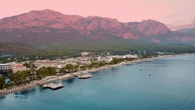 beauty of Kemer from a new perspective with breathtaking aerial view, showcasing a stunning panorama of hotels nestled amidst the scenic mountain landscape.