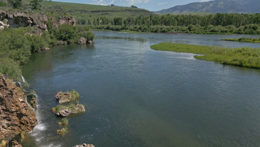 Flying backwards revealing Fall Creek Falls along the Snake River in Swan Valley Idaho.