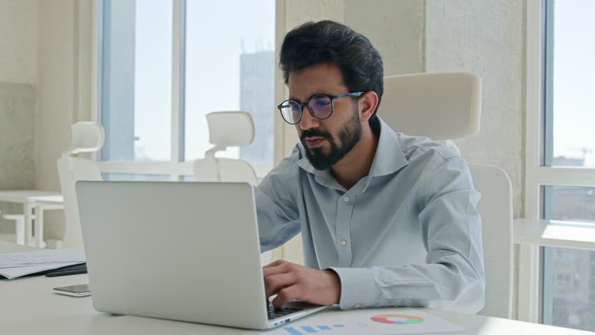 Anxious depressed Indian Arabian man stressed businessman working laptop in office distant job male tired muslim employer worried debt failure business trouble lost deadline crash bankruptcy overwork Royalty-Free Stock Footage #1106348245