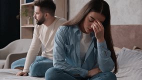 Upset offended woman wife offense to husband family quarrel in bedroom marriage problem relationship difficulties couple sit separately on bed guilty man boyfriend try to apologize after fight breakup - Powered by Shutterstock - Get 15% off with code: PIKWIZARD15