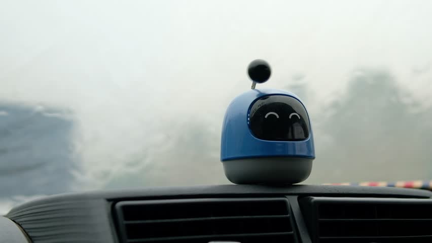 Plastic figure toy on car dashboard