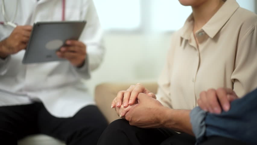 
Husband and wife holding hands mutual support and encouragement from bad news. Husband comforting his wife while sitting together with doctor provides counseling, performs examinations of couples.
 Royalty-Free Stock Footage #1106351763