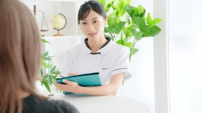 Female medical worker interviewing a patient in medical facility. Nursing. Therapist. - Powered by Shutterstock - Get 15% off with code: PIKWIZARD15
