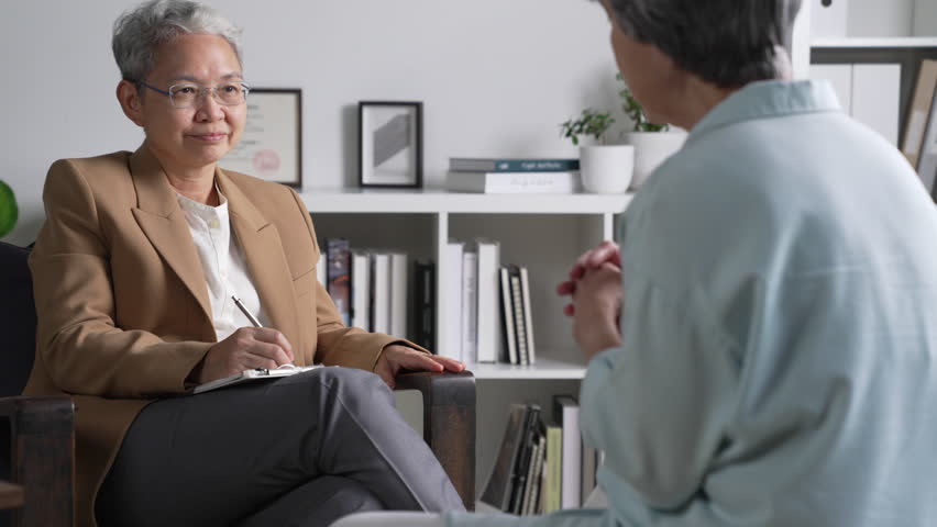 Therapist, psychologist talking and counselling to Asian patient at office during psychology treatment. | Shutterstock HD Video #1106358603