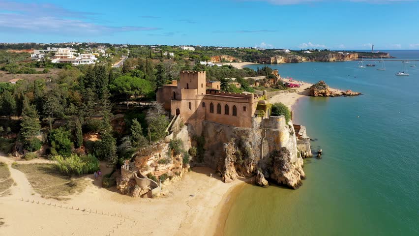 The Fort of Sao Joao do Arade (Castle of Arade) in Ferragudo Village, Algarve. Beach and castle Sao Joao do Arade in Ferragudo in the Algarve in Portugal. Royalty-Free Stock Footage #1106358823