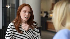 Rear view to two beautiful young best girlfriends sitting and talking to each other in cafeteria communicating and sharing stories, spending relax. Two women friends sitting in cafeteria and talking. - Powered by Shutterstock - Get 15% off with code: PIKWIZARD15