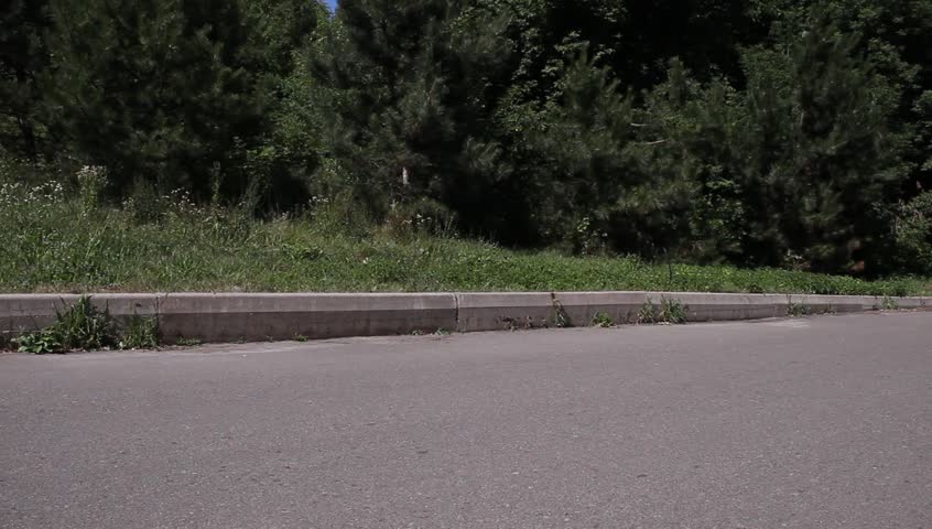 Male Riding Bike Along Park Road