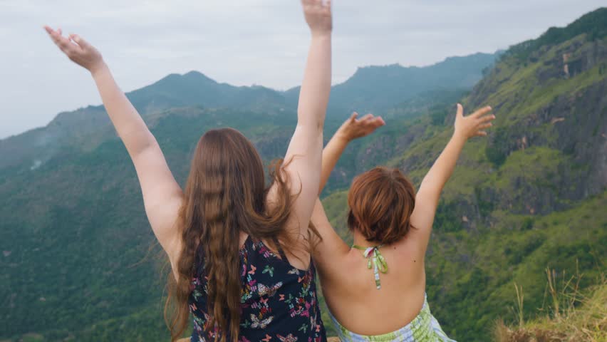Two girls female tourists waving their hands. Ella Valley. Little Adams Peak.