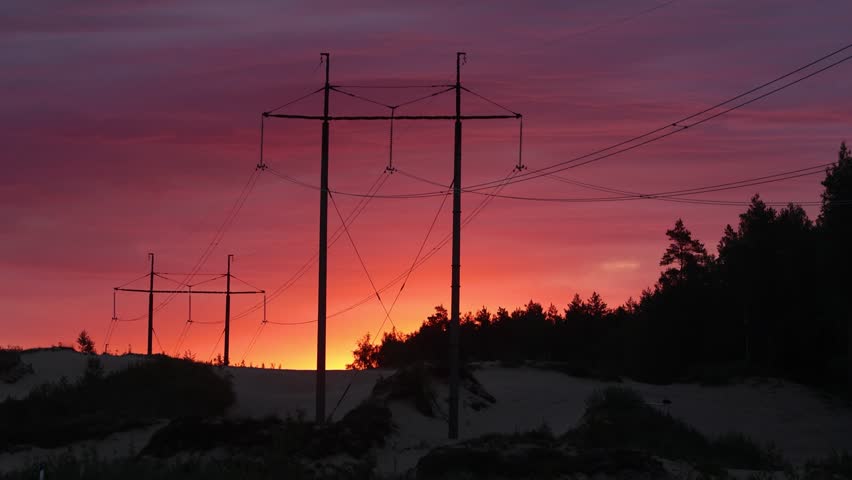 Silhouette of large overhead power lines during sunrise in Estonia, Northern Europe Royalty-Free Stock Footage #1106364547