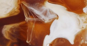 4K footage vertical video Front view SLO MO CU, Pouring milk into black coffee, Concept coffee art.