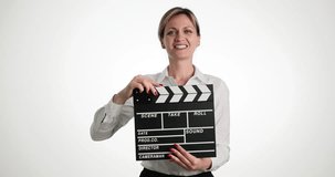 Young woman smiling clips with clapboard on light background