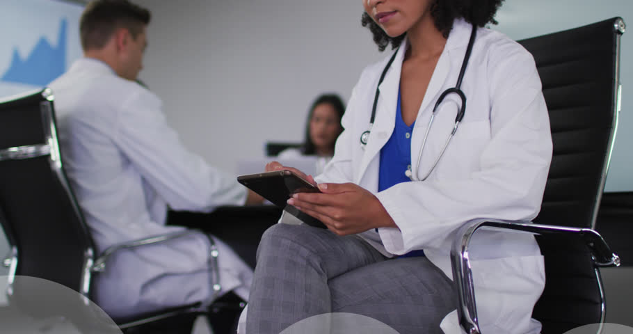 Animation of cloud icons over biracial female doctor. Global medicine, digital interface, , connections, cloud computing and data processing concept digitally generated video.