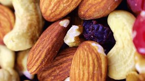 Vertical video format, different nuts and dried fruits mix circle rotation close up