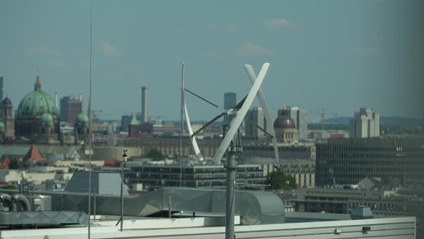 Vertical-axis wind turbine generating renewable energy on a rooftop in Berlin, Germany Royalty-Free Stock Footage #1106381153