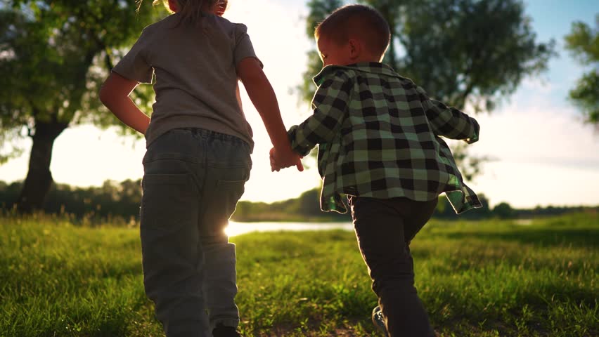 children run holding hands. happy family. silhouette group of children at sunset run through the park in nature. happy family kid dream concept lifestyle. happy kids running together silhouette Royalty-Free Stock Footage #1106381655