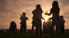 group silhouette volunteers clean up trash. environmental protection ecology cleaning from world garbage plastic concept. group people volunteers collects plastic bottles garbage in bags nature - Powered by Shutterstock - Get 15% off with code: PIKWIZARD15