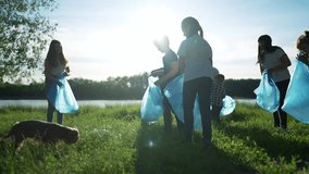 group of volunteers clean up trash. environmental protection ecology cleaning from garbage plastic concept. group people volunteers collects plastic world bottles garbage in bags silhouette - Powered by Shutterstock - Get 15% off with code: PIKWIZARD15