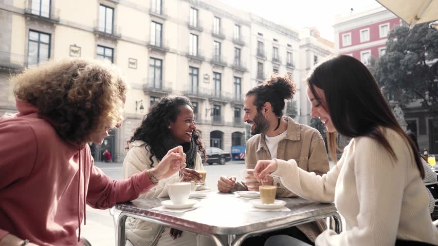 Friends group toasting latte at coffee bar terrace. Group of people talking and having fun together at cappuccino restaurant. Lifestyle concept with happy men and women. High quality photo Royalty-Free Stock Footage #1106381789