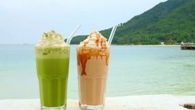 Delicious soft drinks in summer restaurant on ocean. Cinematic video of fragrant soft drinks with transparent eco straw on holiday. Enjoy tropical view with refreshing soft drinks in summer restaurant