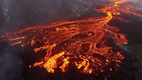 Volcano eruption in 2023, Red burning lava erupts from the ground in Iceland. Formation of a new active volcano. Aerial footage.