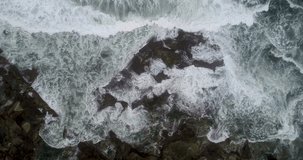 aerial drone video of waves on a rocky coast