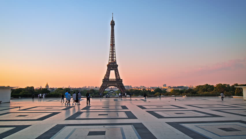 Views of the Tower from Trocadero in Paris, France. Tourists enjoy historical landmark and symbol of Paris at sunrise in Paris. Royalty-Free Stock Footage #1106385259