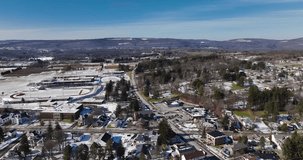 Sunny mid afternoon winter aerial video of Tully, NY, USA.