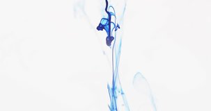 Slow motion video of blue watercolor ink mixing in water against grey background. Beautiful abstract background concept